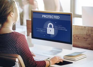 Woman working on computer network graphic overlay