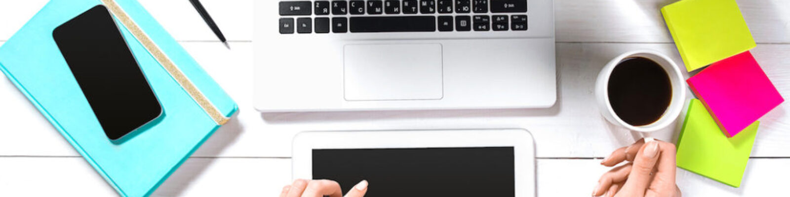 Hand use white tablet on desk table top view